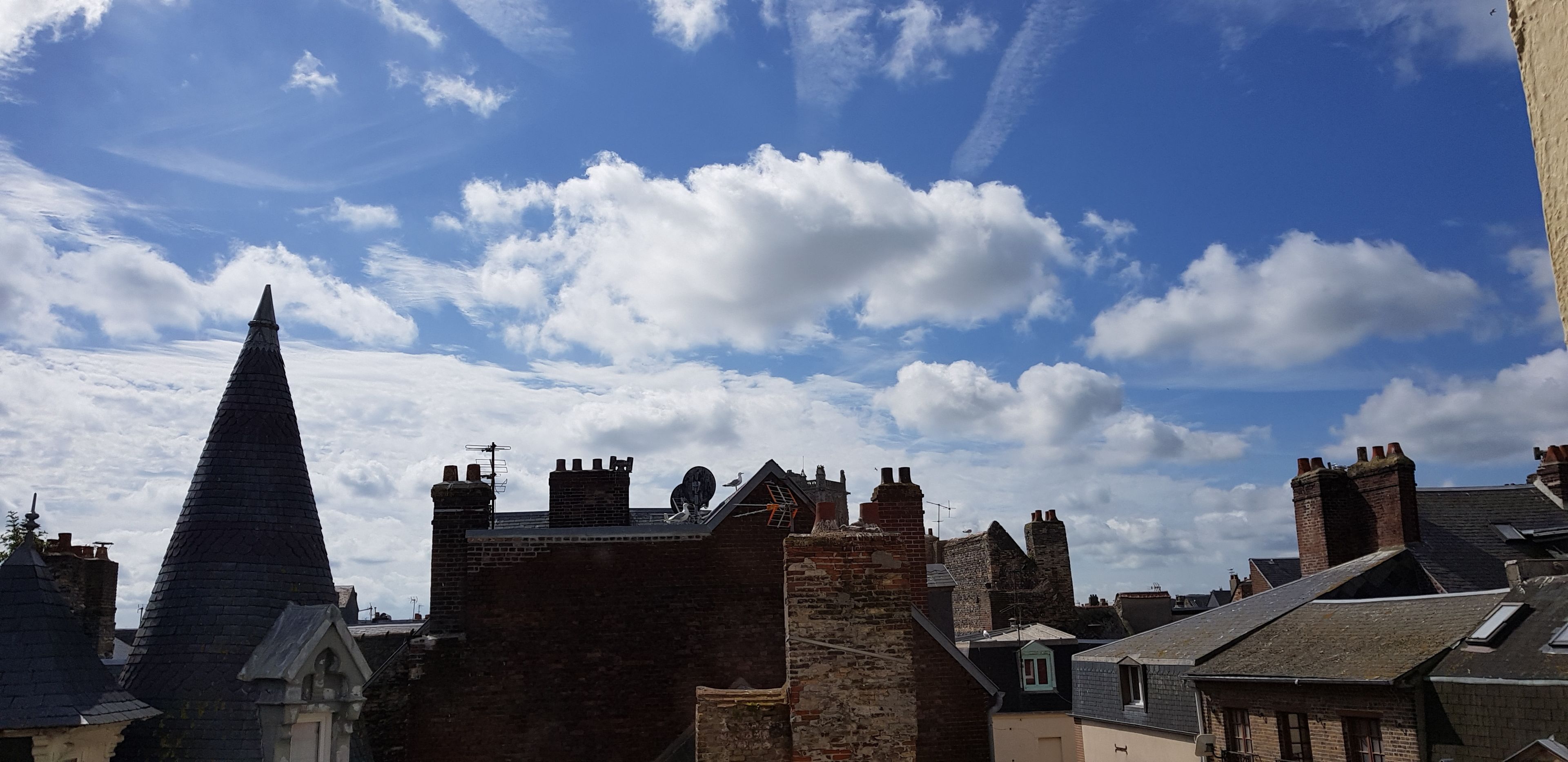 A historic town with a prominent church spire and traditional brick buildings.