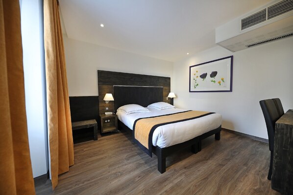 A hotel room with a bed, bedside tables, a desk, and a chair. - Hôtel Restaurant de la Jamagne (Gerardmer)
