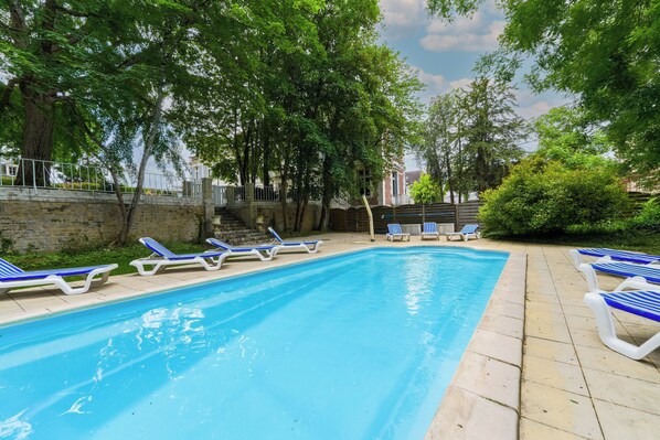 Outdoor pool, open 9:00 AM to 8:00 PM, pool loungers