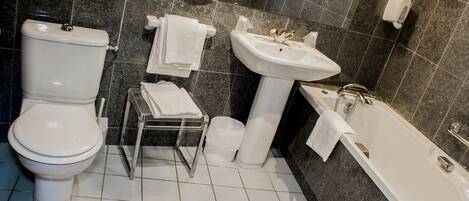 A modern bathroom with a toilet, sink, and bathtub.