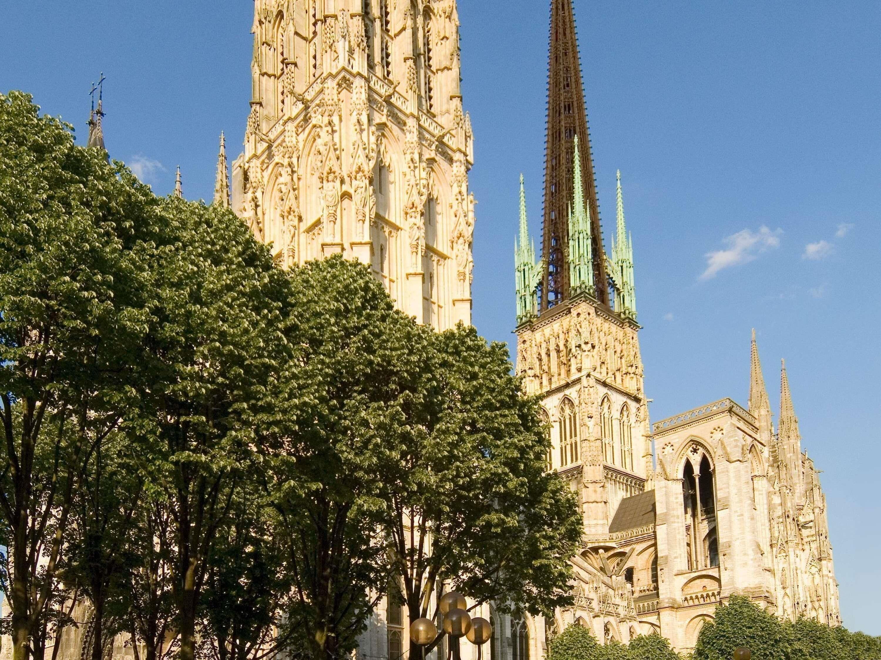 A historic cathedral with intricate architecture, including a tall spire and detailed stonework.
