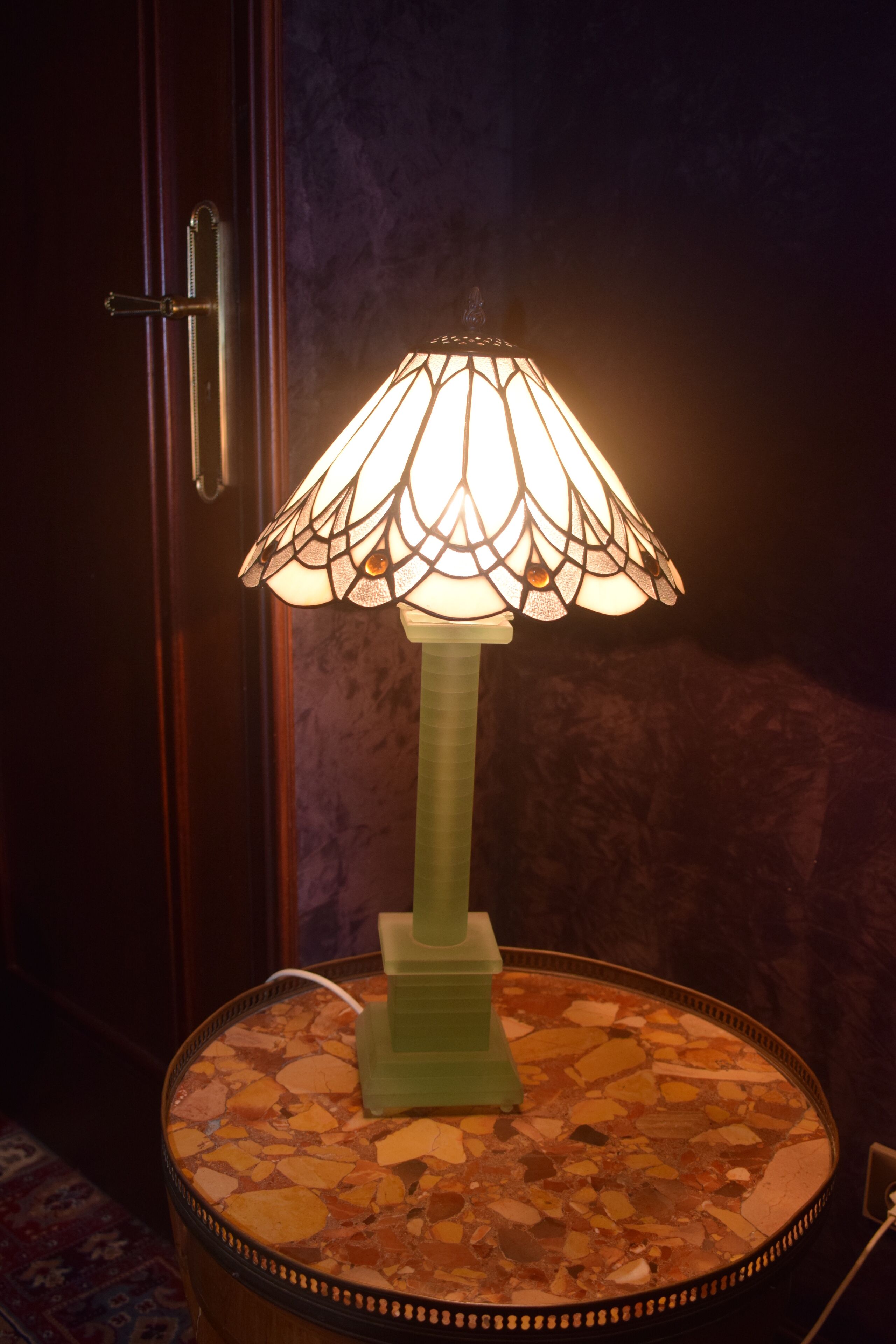 A table lamp with a mosaic tabletop.