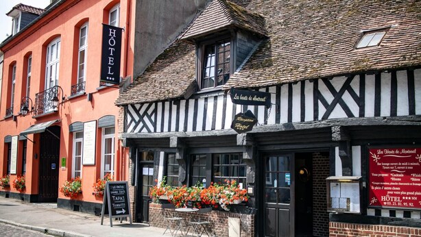 A traditional building with a sign reading "HOTEL" and another sign indicating "Les Hauts de Montreuil." - Les Hauts de Montreuil (Montreuil-sur-Mer)