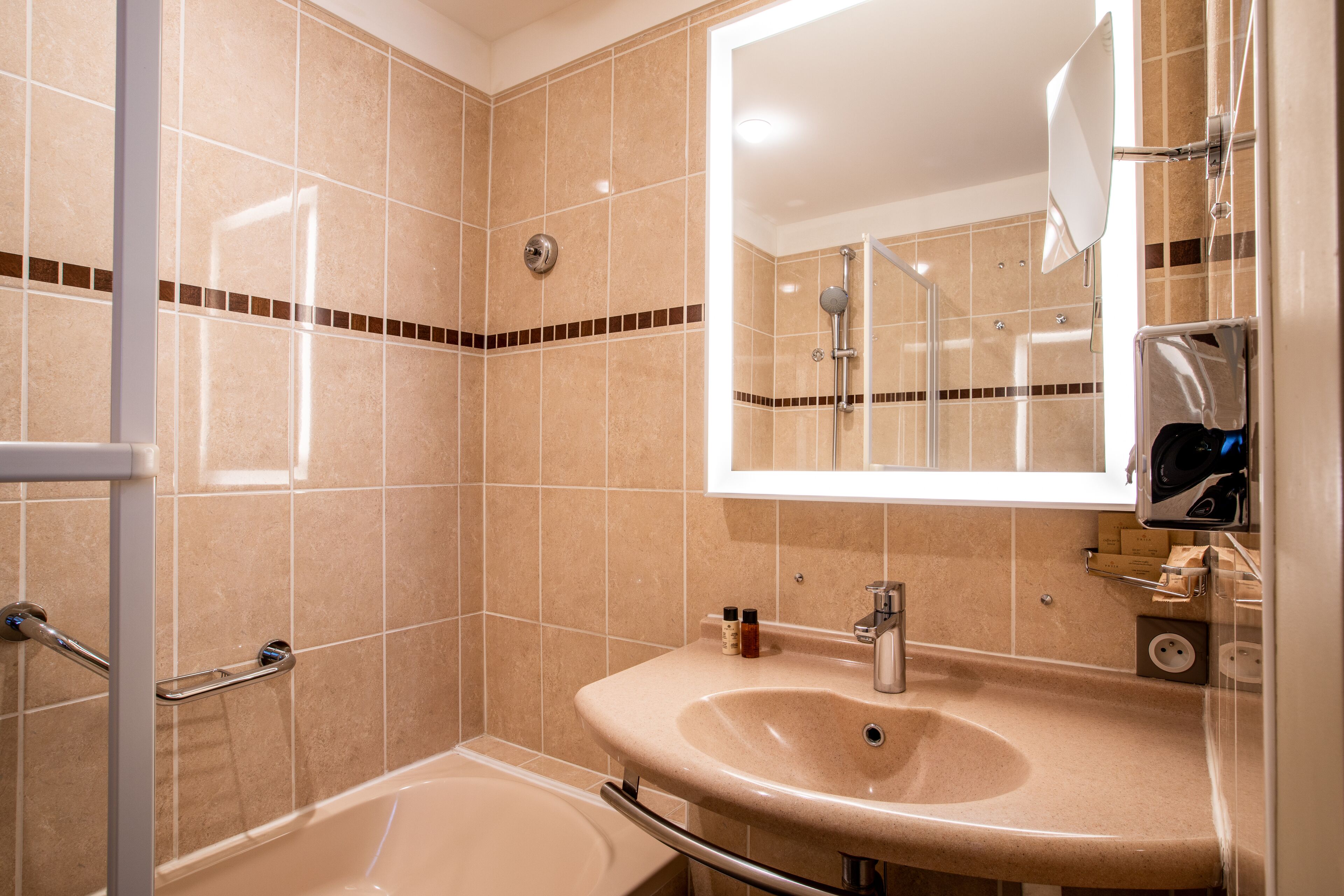 A bathroom with a bathtub, a sink, a mirror, and a shower.