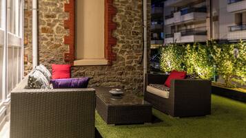 Relax in this serene outdoor seating area with wicker sofas and a coffee table.