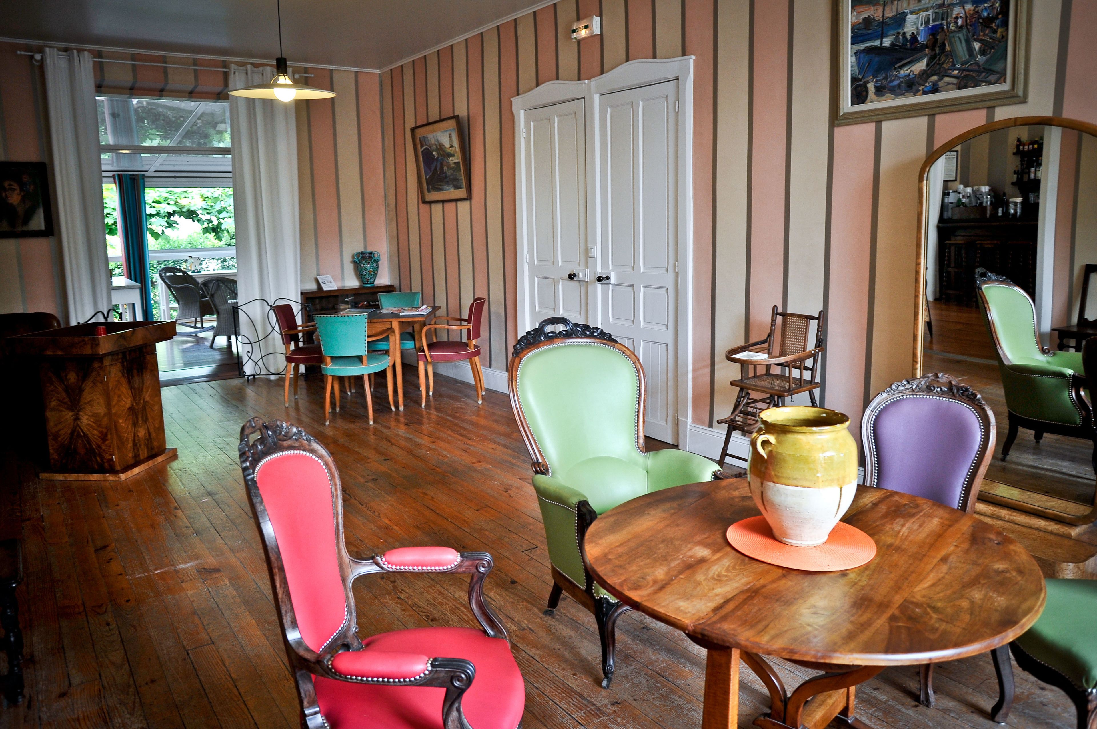 A dining area with a wooden table, chairs, and a vase.