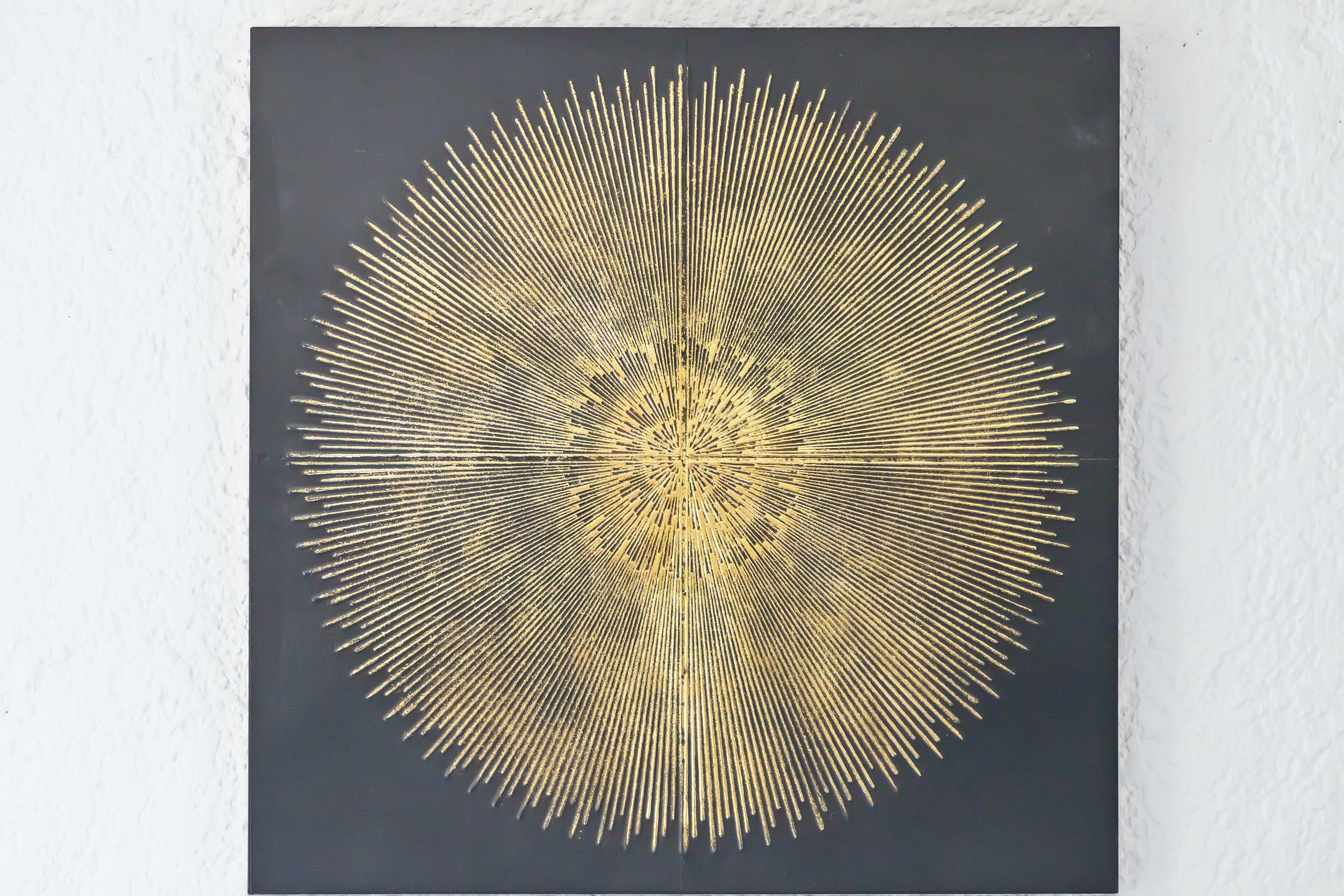 A circular pattern with radiating lines on a dark background.