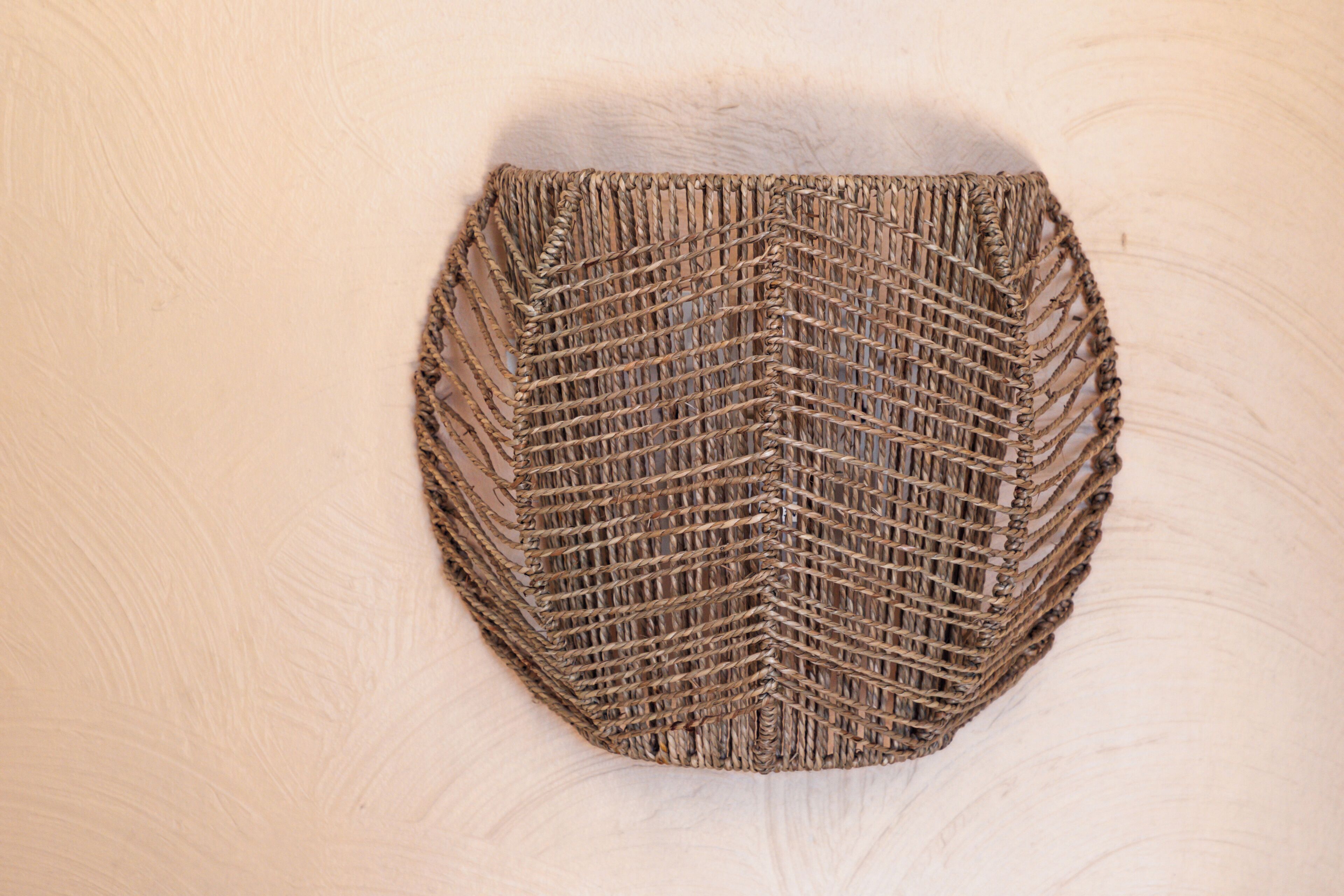 A woven wall hanging with a geometric pattern.