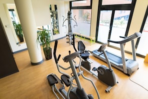 Stay active with our fully equipped gym featuring elliptical trainers, treadmills, and a bench.