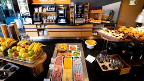 A buffet with various food items and a coffee station.