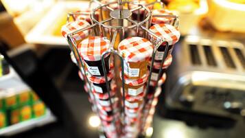 A display of jars with checkered lids, possibly containing jam or preserves, arranged on a metal rack.