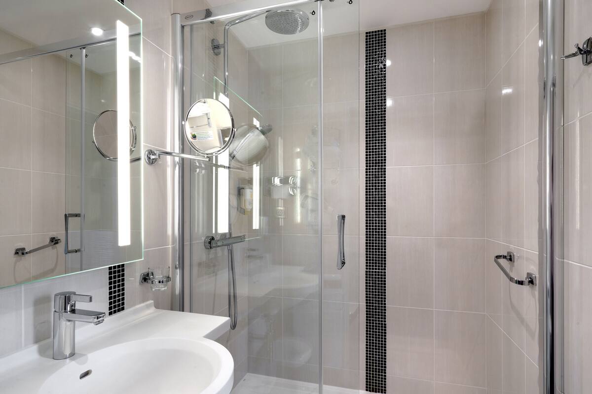 comfort plus room, 1 king bed | bathroom | shower, hair dryer, towels