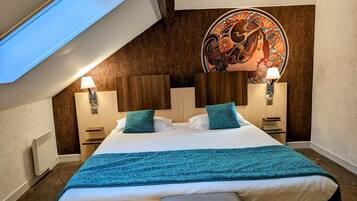 A modern bedroom with a skylight, a large bed with teal bedding, two bedside tables with lamps, and a decorative headboard.