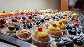 A variety of pastries and desserts arranged on a display counter.