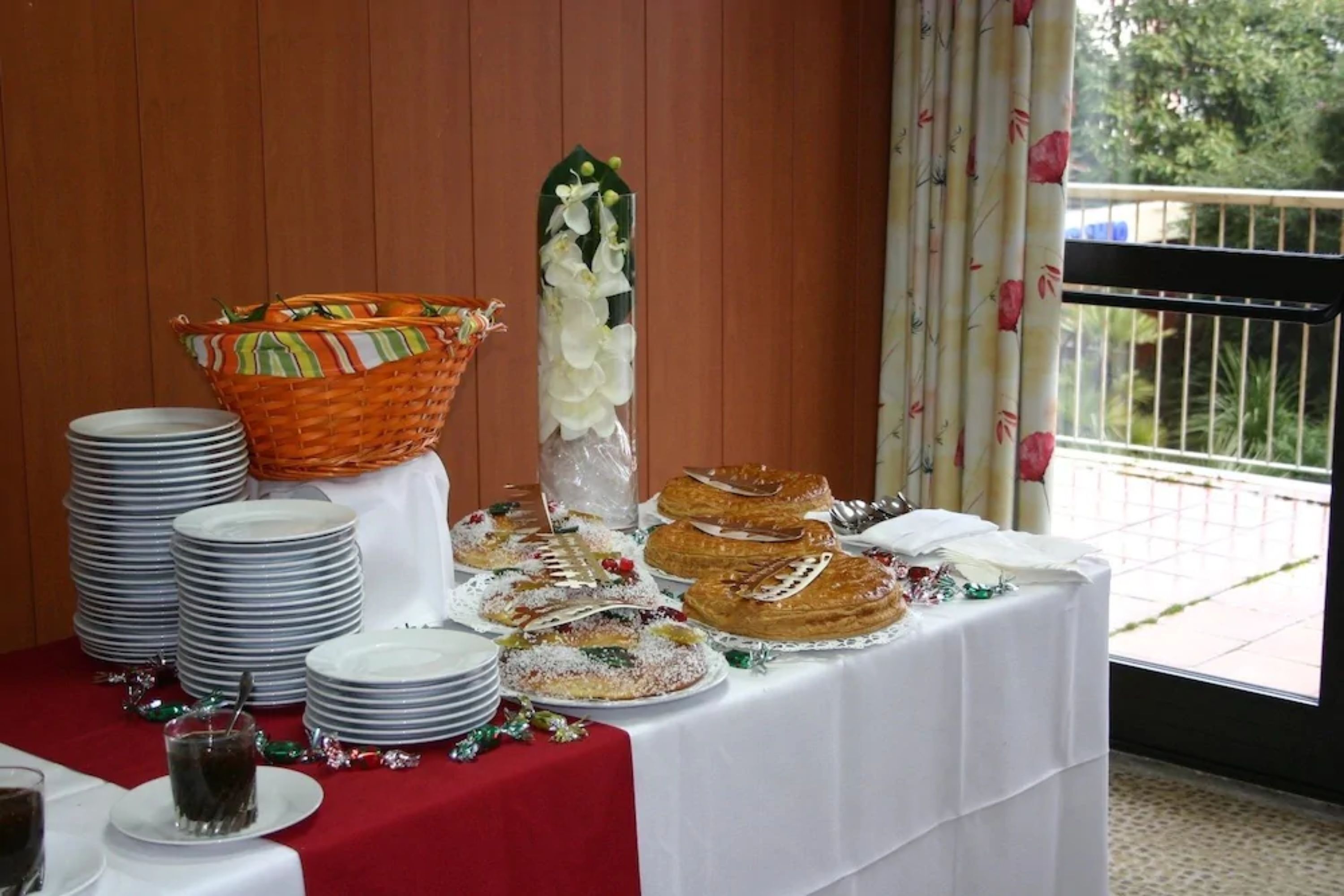 A buffet table with various dishes, a decorative vase, and a wicker basket.