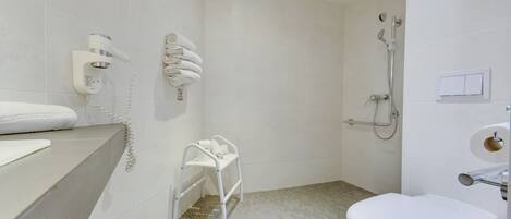 A bathroom with a toilet, a shower, a towel rack, and a hairdryer.
