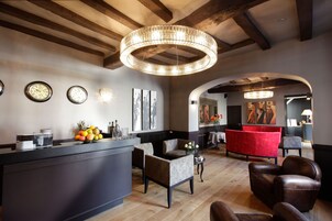 A modern interior with a bar area, seating, and artwork.