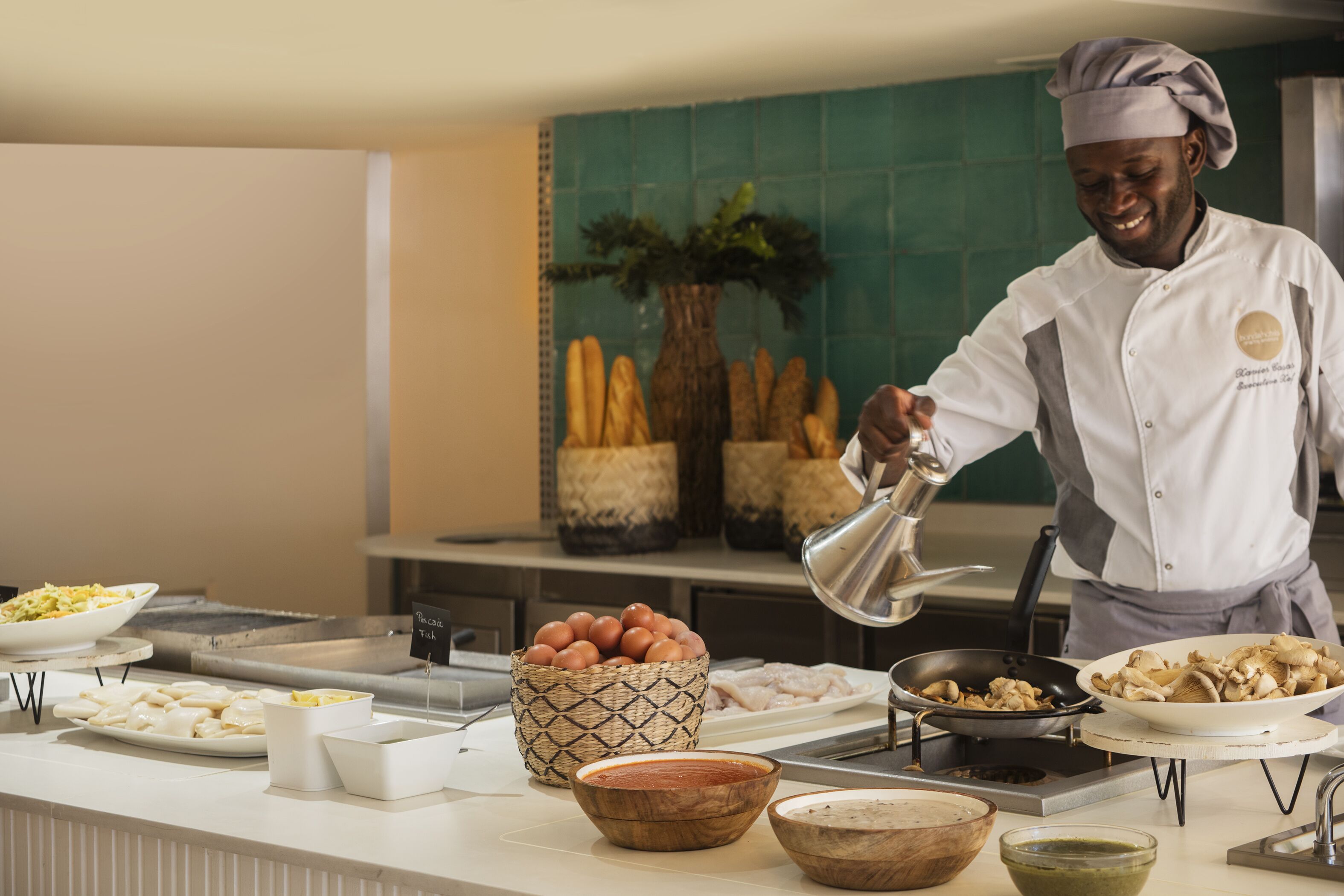 A chef preparing food in a kitchen with various dishes and ingredients on the counter.