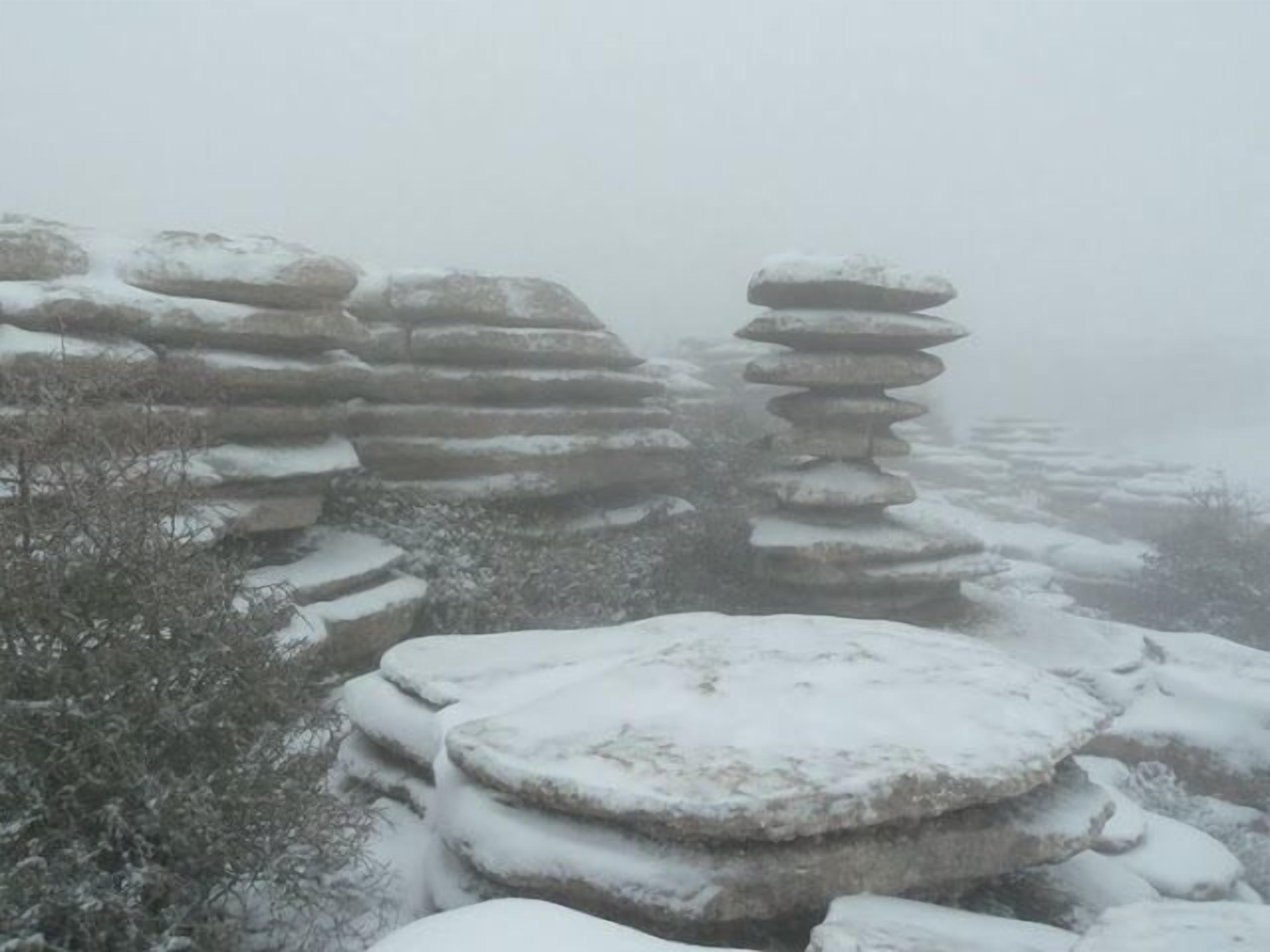 A snowy landscape with stacked stone formations.