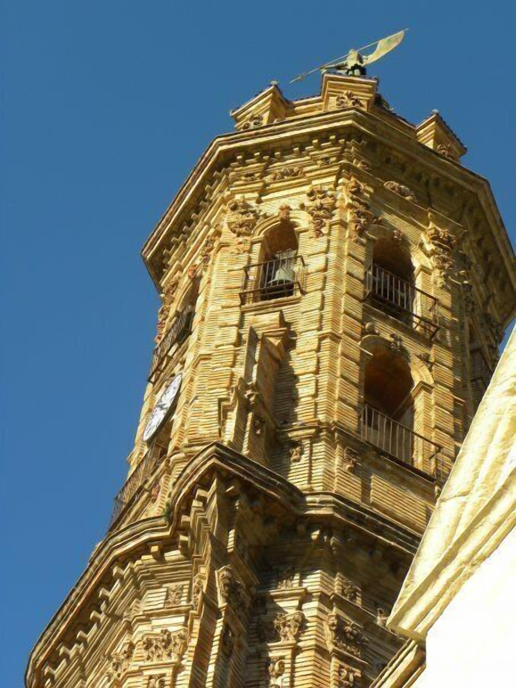 A historic building with intricate stone carvings and a clock tower.