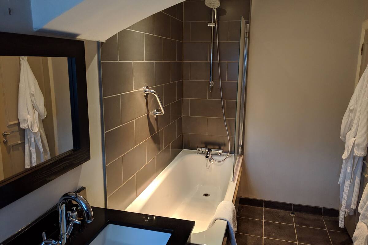 superior double room single use, 1 double bed, garden view | bathroom | combined shower/bathtub, free toiletries, hair dryer, towels