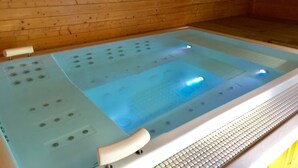 A wooden cabin interior with a hot tub featuring a control panel and a wooden wall with a 'RELAY' sign. - Hedley House Hotel Wellness and Spa (York)