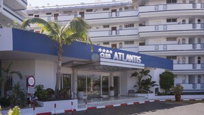 A hotel entrance with a sign reading "Club ATLANTIS," a covered entrance, and a palm tree. - Hovima Atlantis (Adeje)