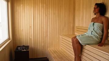 A sauna with wooden benches and a window.