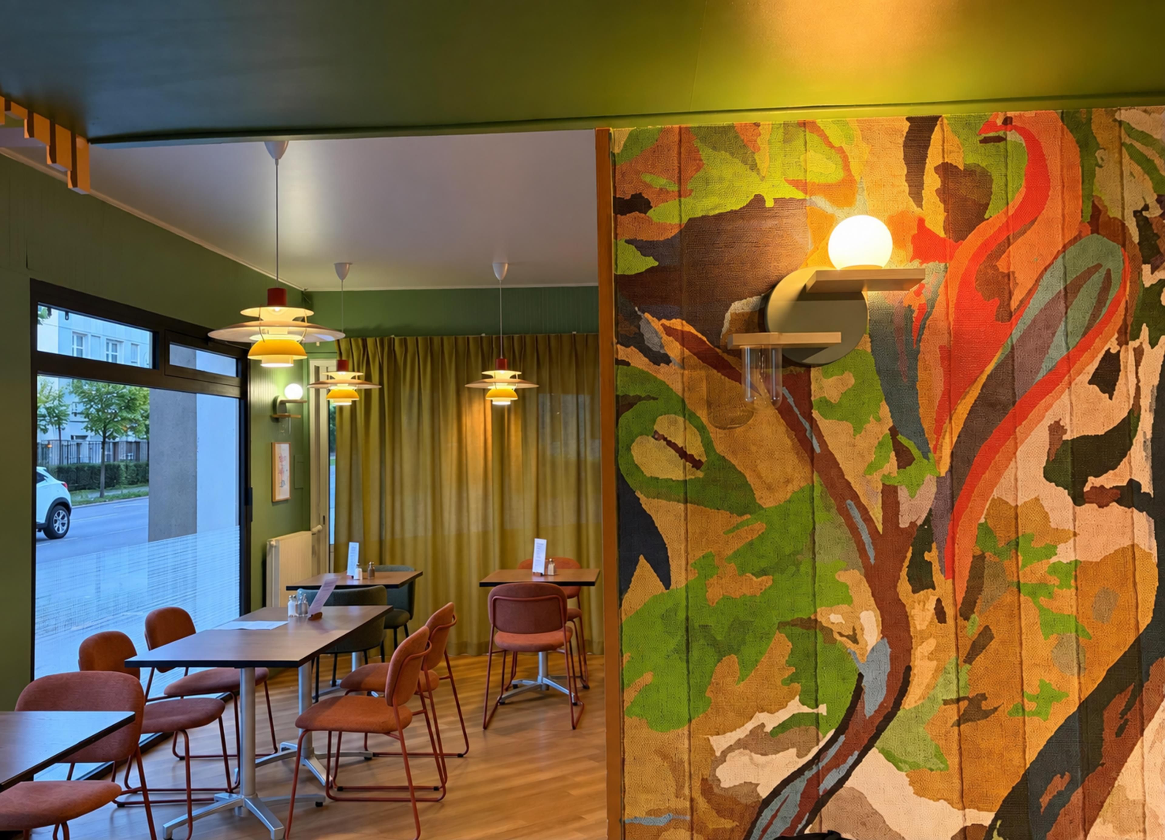 A room with a dining area, chairs, tables, and a large abstract painting on the wall.