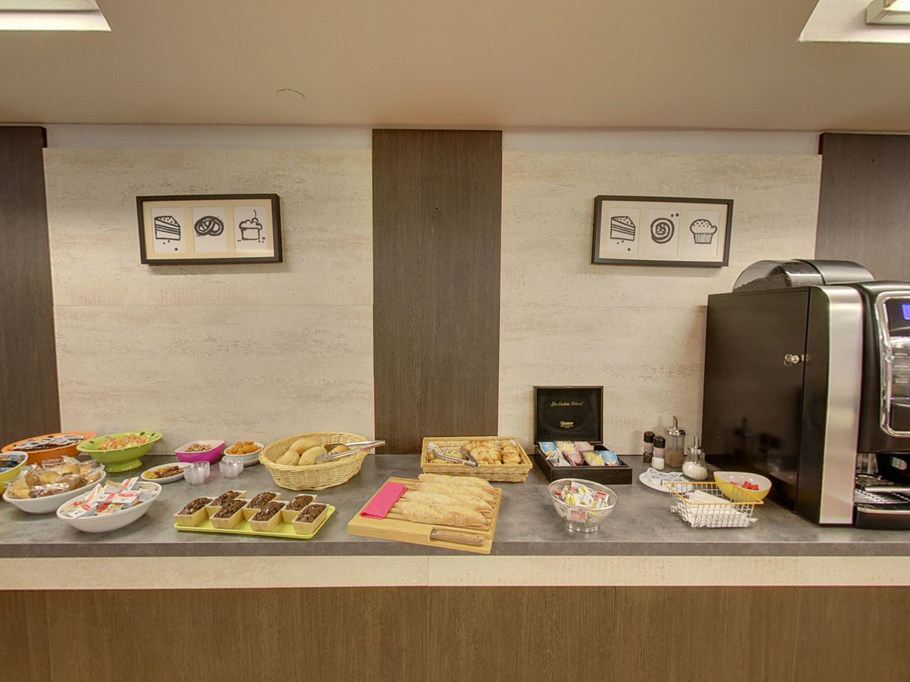 A buffet setup with various food items and a coffee machine.