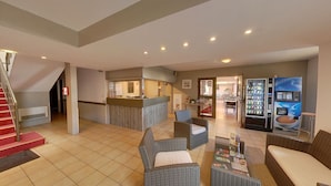 A hotel lobby with a reception desk, seating area, and a staircase. - The Originals Access, Hôtel Béziers Est (Villeneuve-les-Beziers)