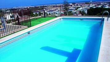 Outdoor pool, open 10:00 AM to 8:00 PM, pool umbrellas, pool loungers
