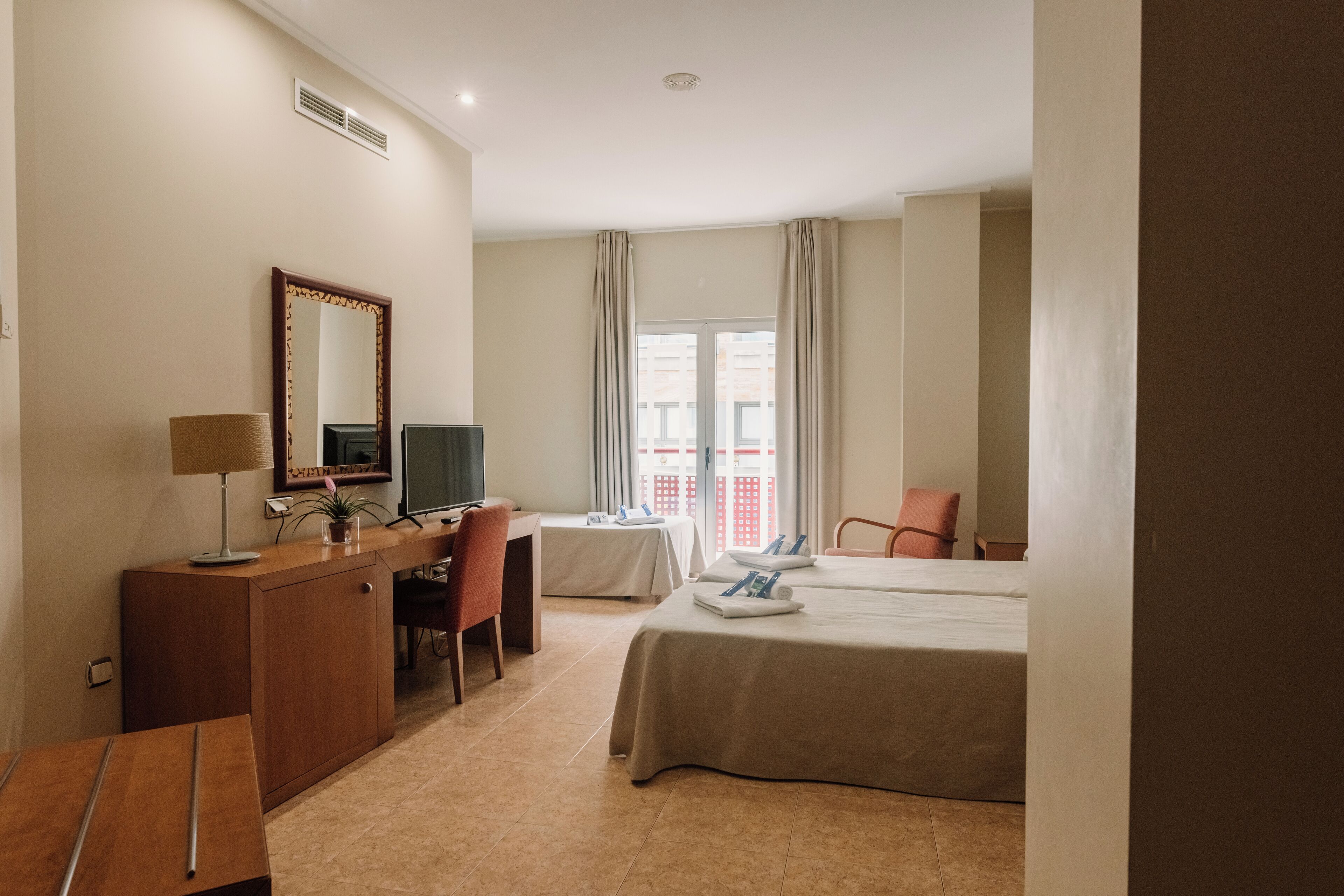 family room | down duvets, minibar, in-room safe, desk