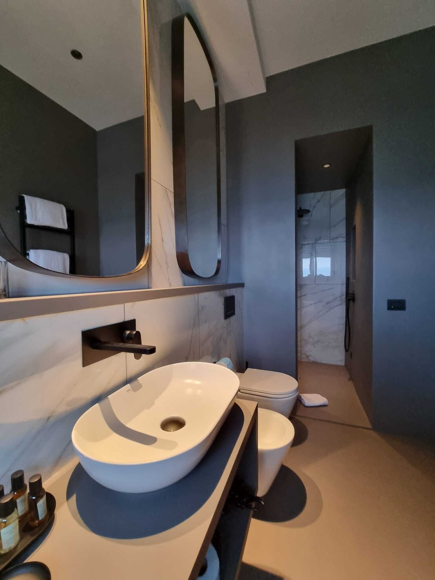 presidential studio suite | bathroom | rainfall showerhead, free toiletries, hair dryer, slippers