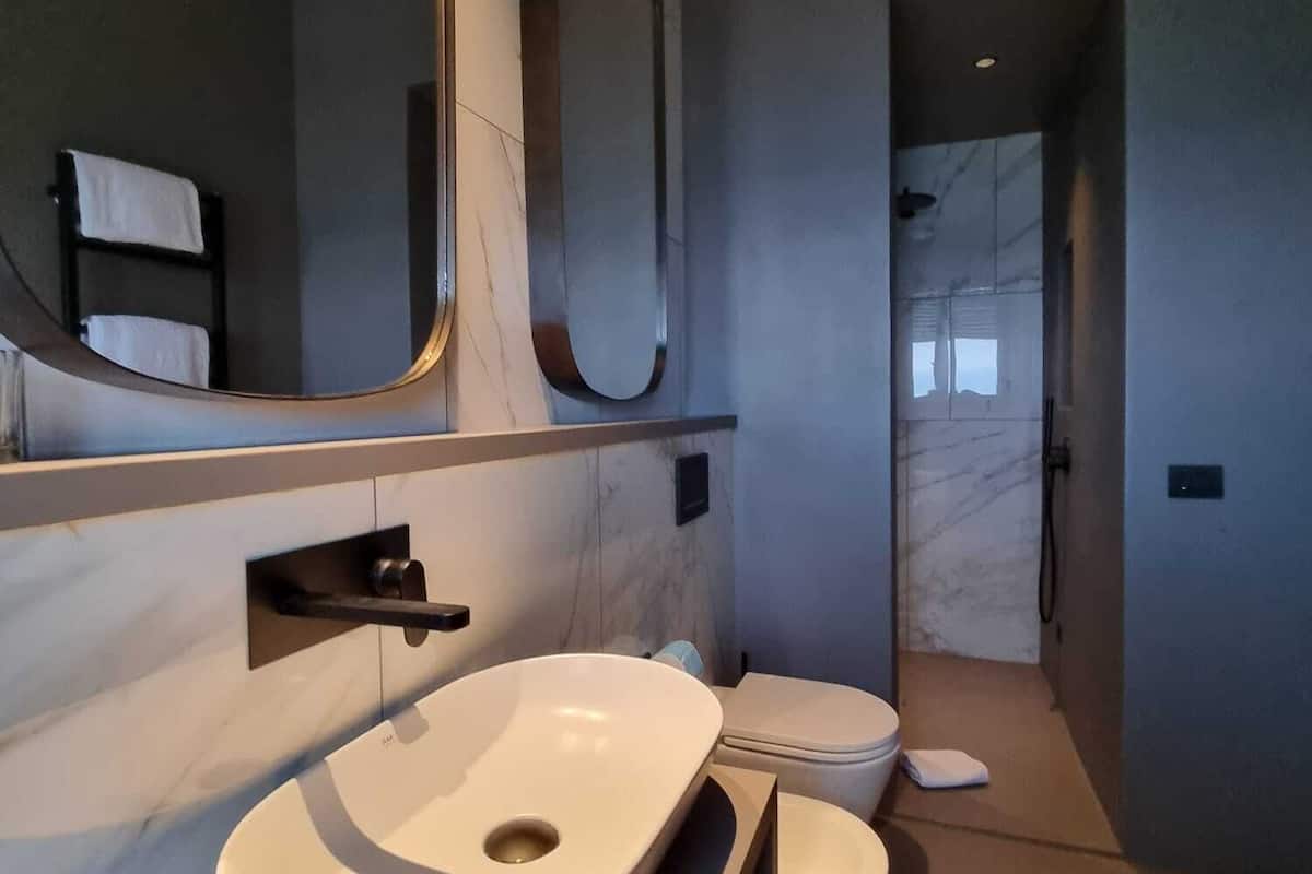 presidential studio suite | bathroom | rainfall showerhead, free toiletries, hair dryer, slippers