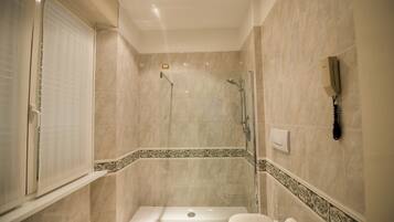 A bathroom with a bathtub, toilet, and shower.