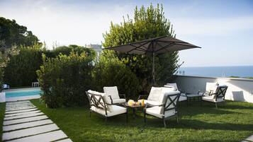 A patio area with outdoor furniture and a pool.