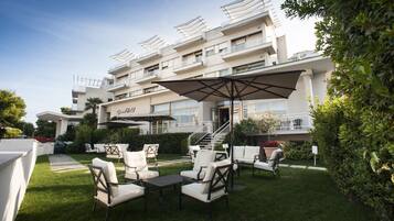 Relax in style with comfortable seating and shade under a large umbrella.