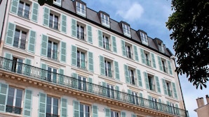 Un edificio de varios pisos con balcones y persianas.