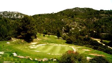 Un campo de golf con un green bien cuidado, búnkeres de arena y un marcador de posición.
