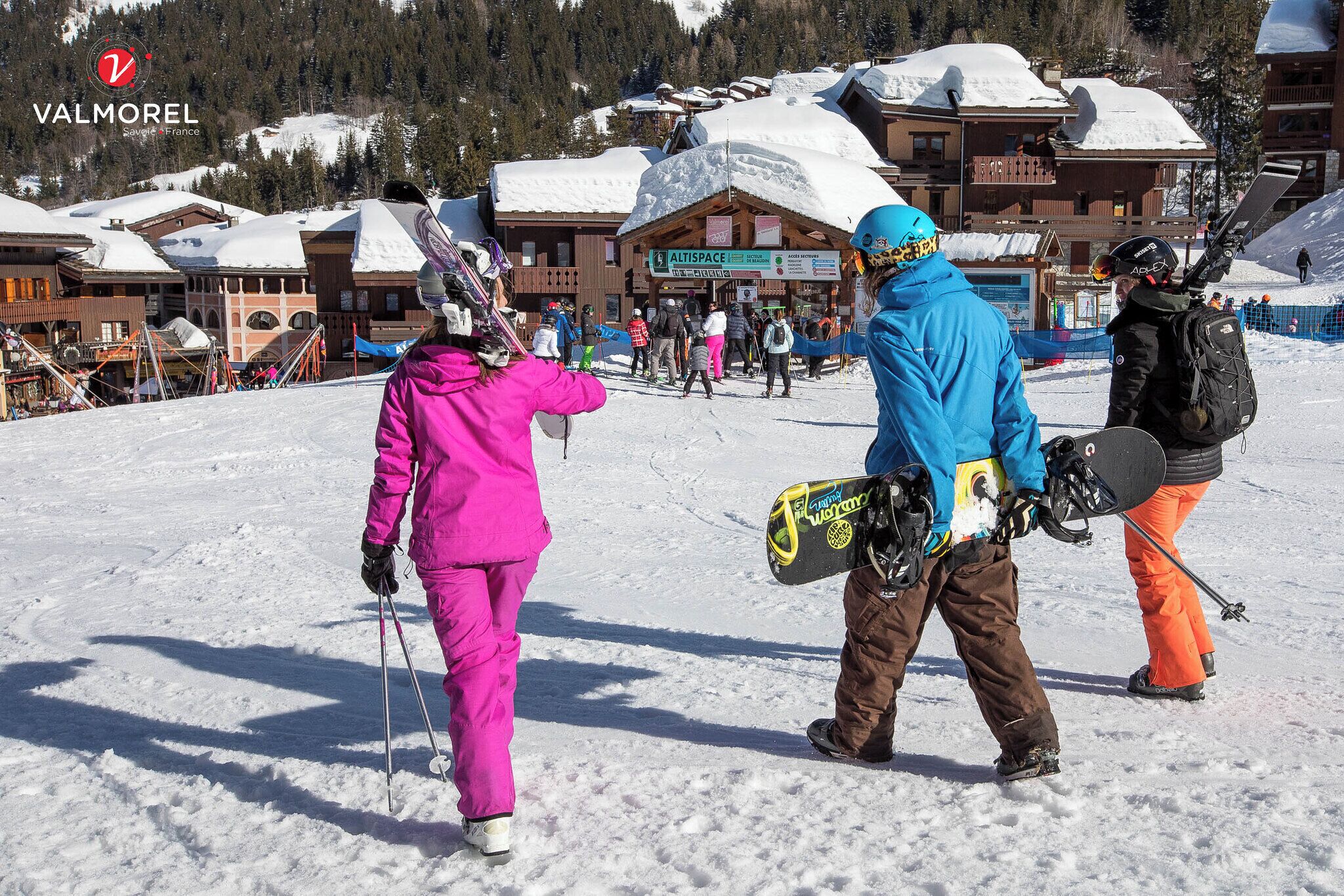 A ski resort with buildings, snow-covered roofs, and a sign for 'Altispace'.