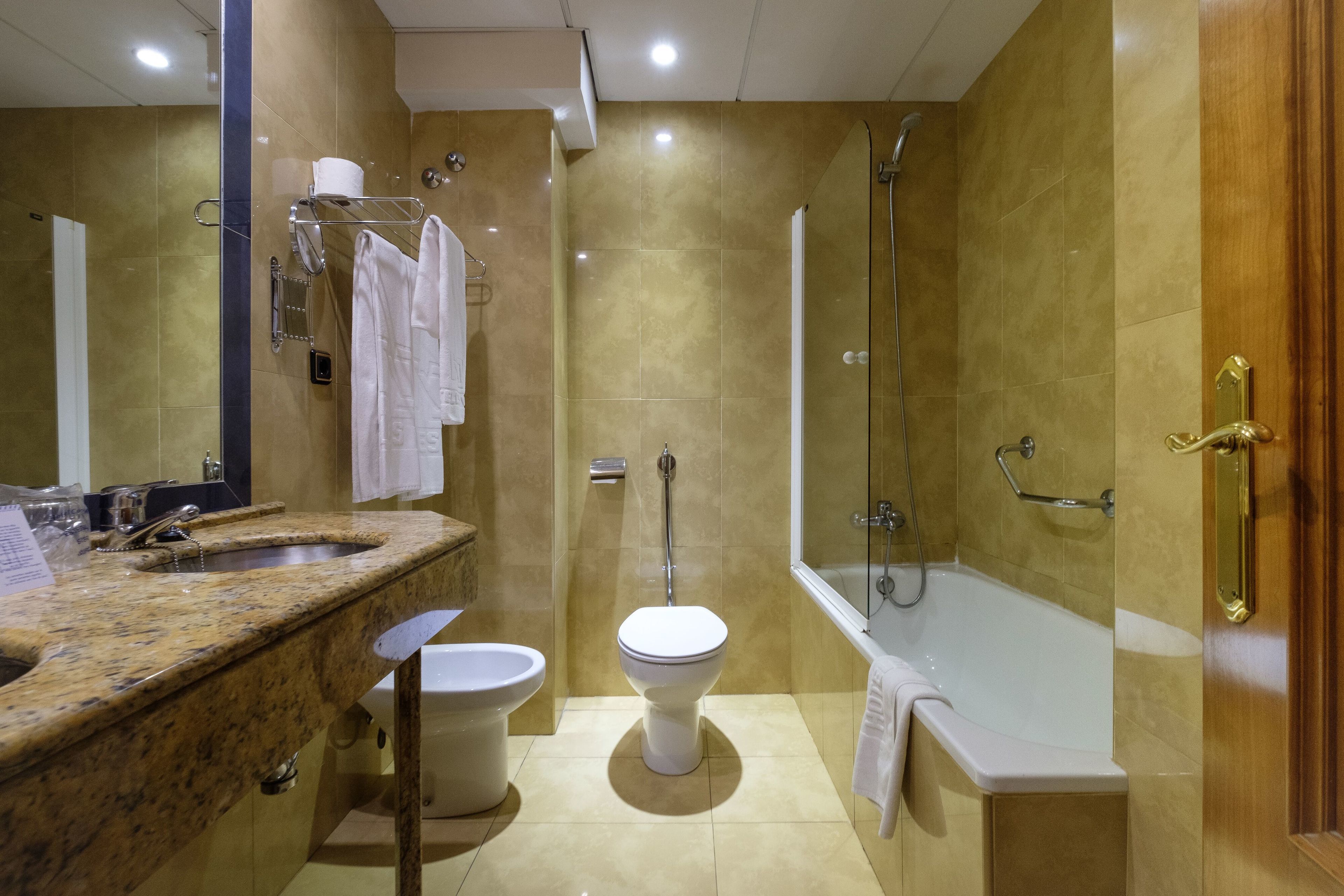 double room (2 single beds,interior patio view) | bathroom | combined shower/bathtub, free toiletries, bidet, towels