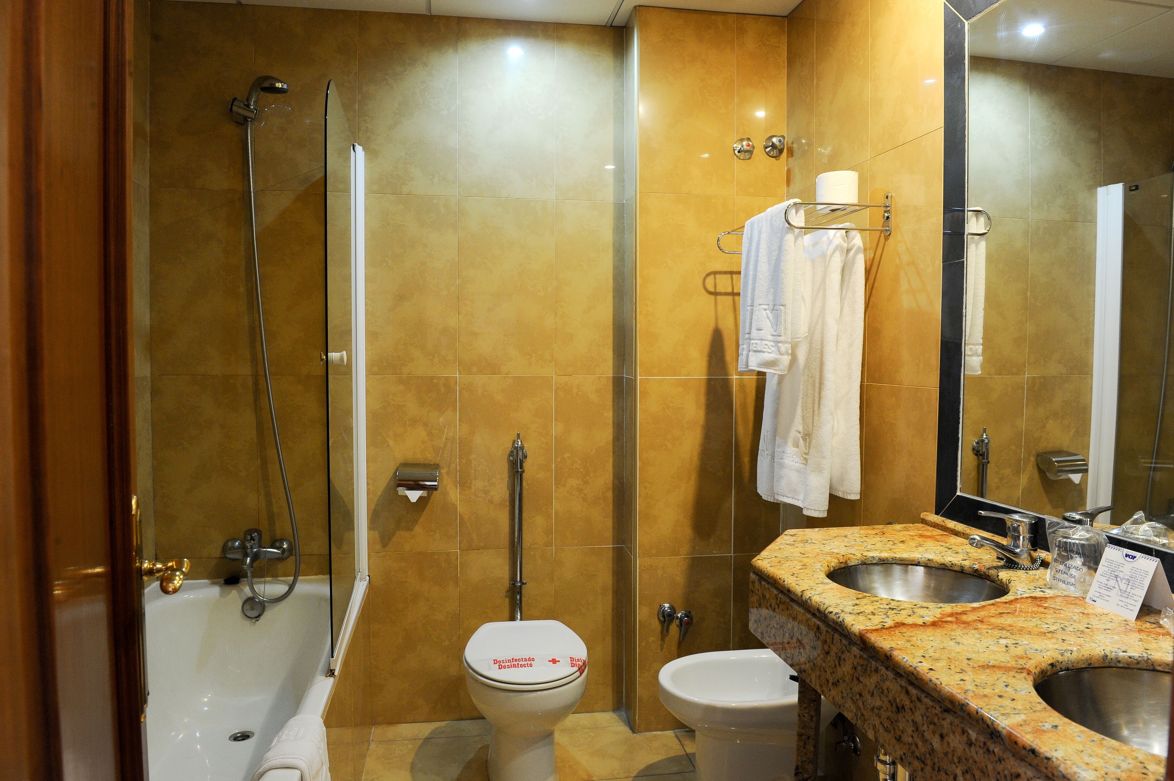 A bathroom with a bathtub, toilet, and sink.