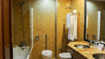 A bathroom with a bathtub, toilet, and sink.