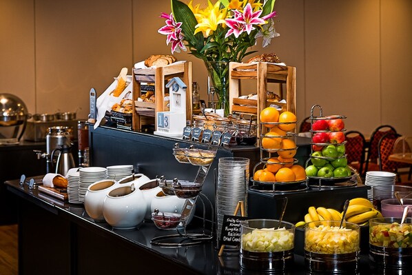 A buffet with various food items, including fruits, pastries, and condiments. - Kilmurry Lodge Hotel (Limerick)