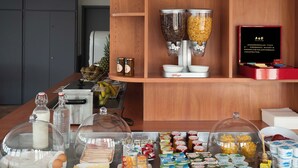 A breakfast buffet with various food items and condiments.