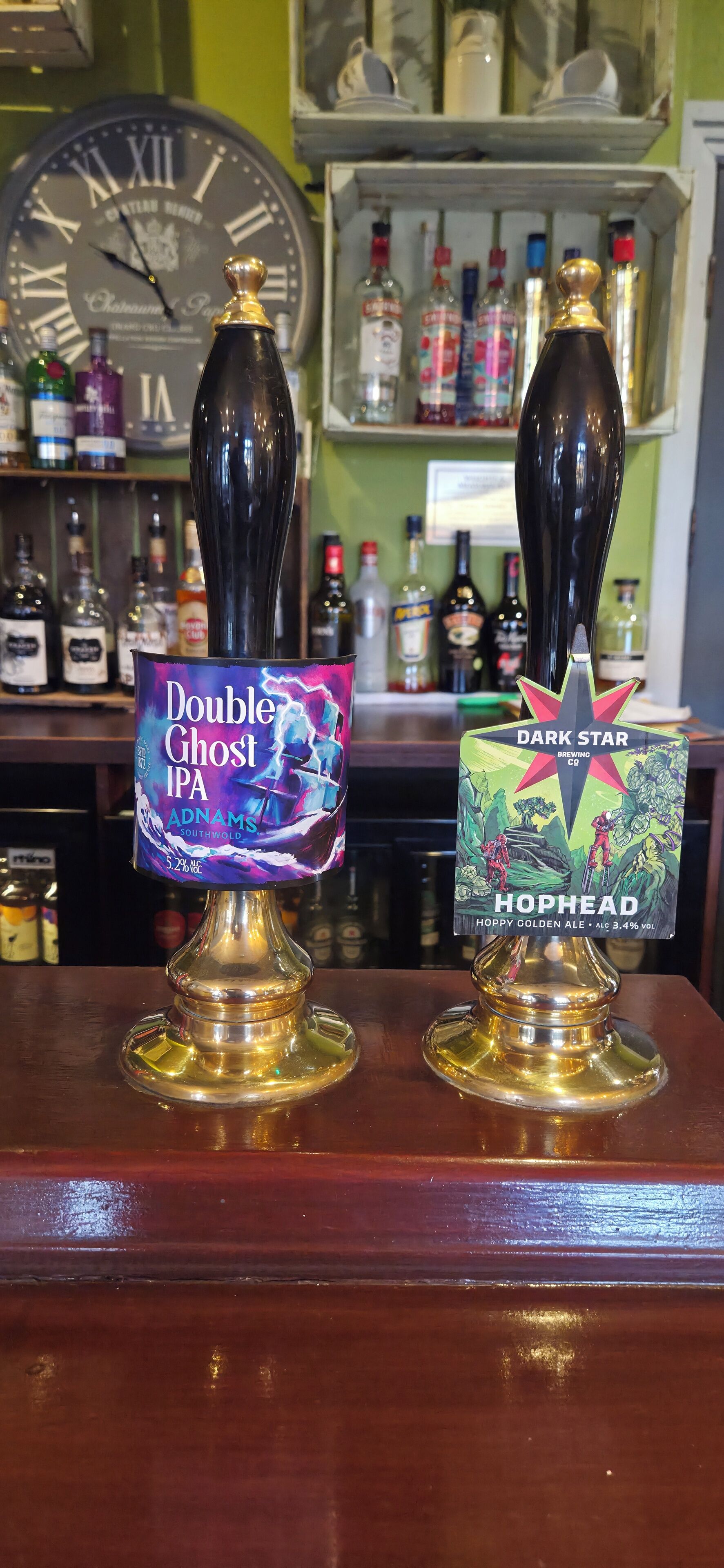 Two tap handles with labels for Double Ghost IPA and Dark Star Hophead Hoppy Golden Ale.