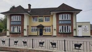 A two-story building with 'The Woolpack' signage on both the ground and upper floors. - The Woolpack Inn (Chichester)