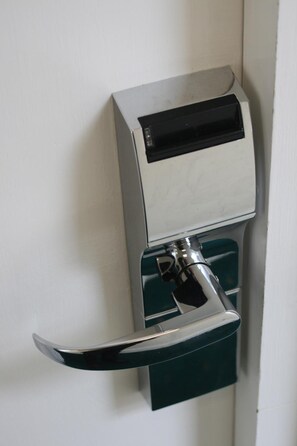 A door with a built-in intercom system and a keycard reader. - The Hanover Hotel (Liverpool)