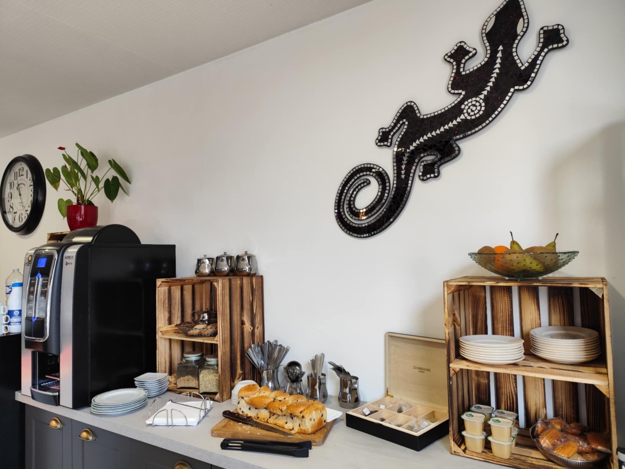 Een keukentafel met een koffiezetapparaat, een brood en een fruitschaal.